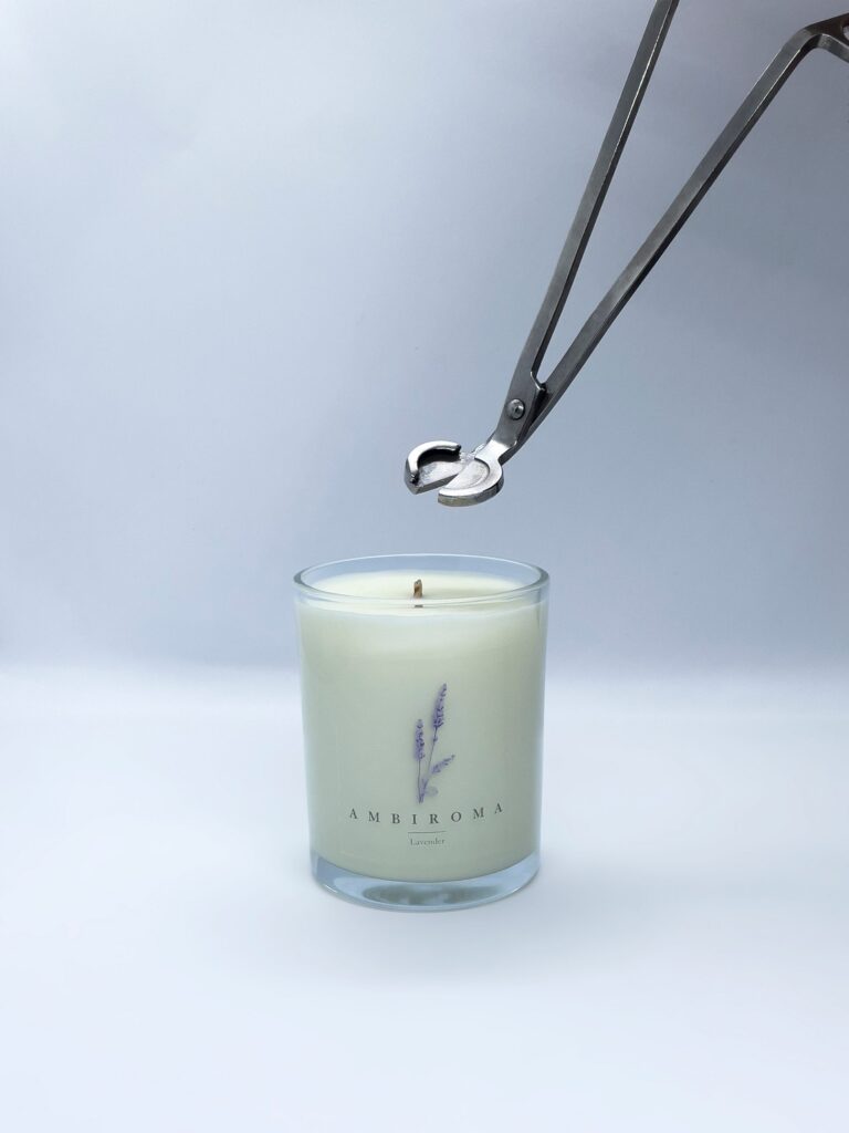 lavender candle with scissors clipping wick